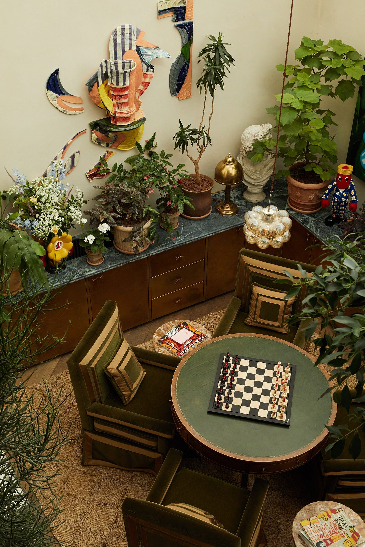 The games area which features a Philip Colbert lobster chess set on a vintage card table.