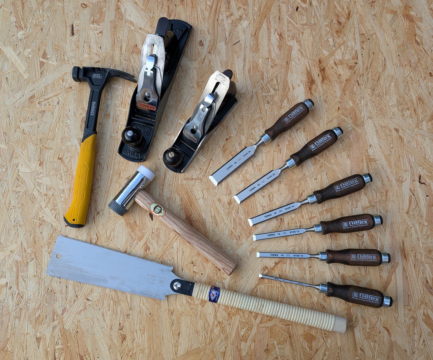 Ryoba saw, chisels, mallet, Jack and smoothing plane, representing core woodworking tools for beginners.
