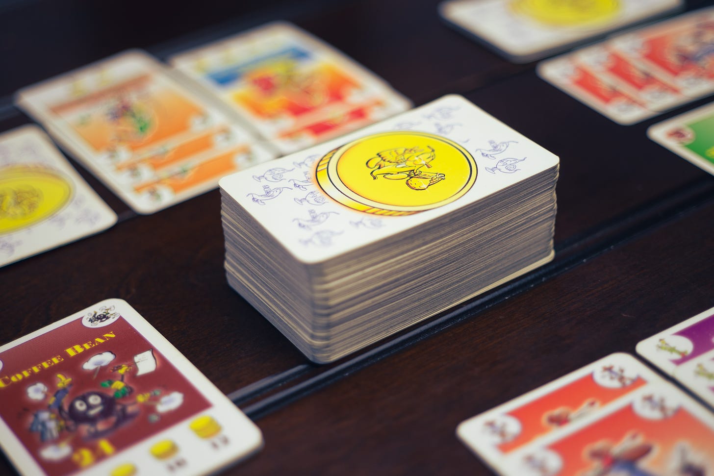 Cards from the game Bohnanza on a table. In focus is the coffee bean card.