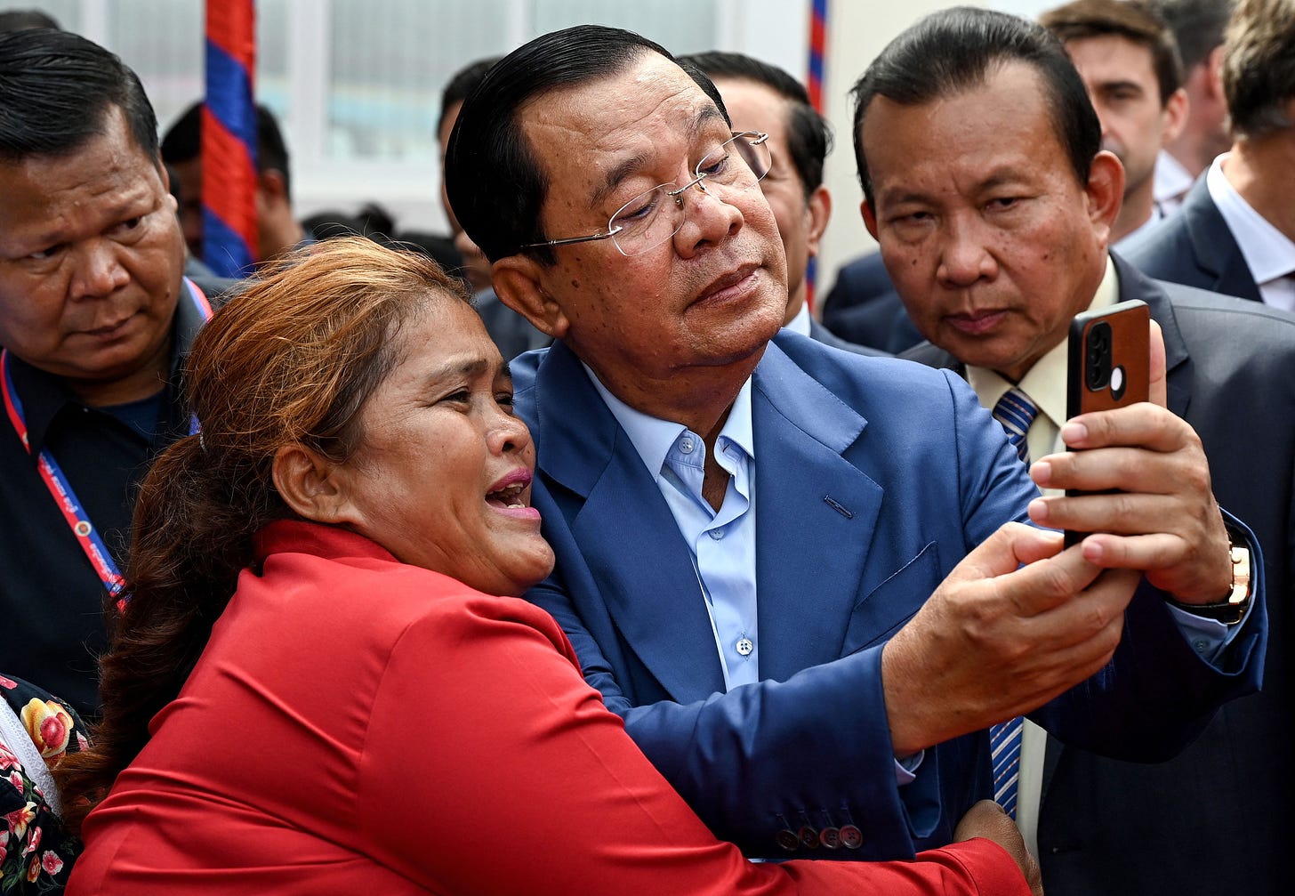 Cambodian Prime Minister Hun Sen takes a selfie with a supporter in June. (Tang Chhin Sothy / Getty Images)