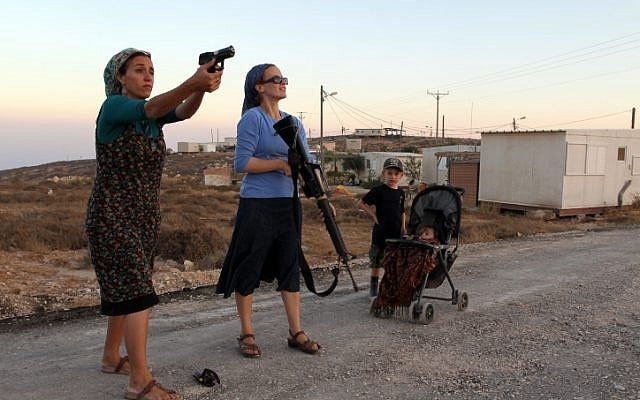 Female Israeli settlers practice firing weapons at the settlement of “Pnei Kedem”, near the occupied West Bank in September. (Flash90)