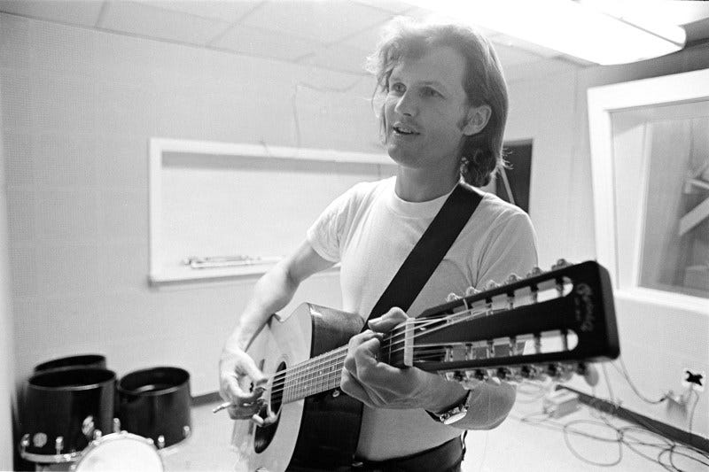 Actor, singer, songwriter, musician, Kris Kristofferson wearing a white T shirt plays an acoustic twelve string guitar and holding a cigarette at Combine Studios, Nashville, Tennessee in 1970.   (Photo by Al Clayton/Getty Images).