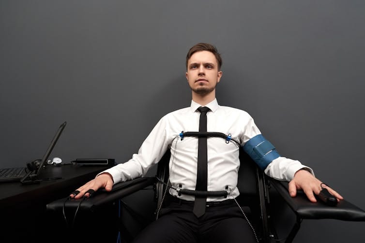 Man taking a lie detector test. Man taking a lie detector test.