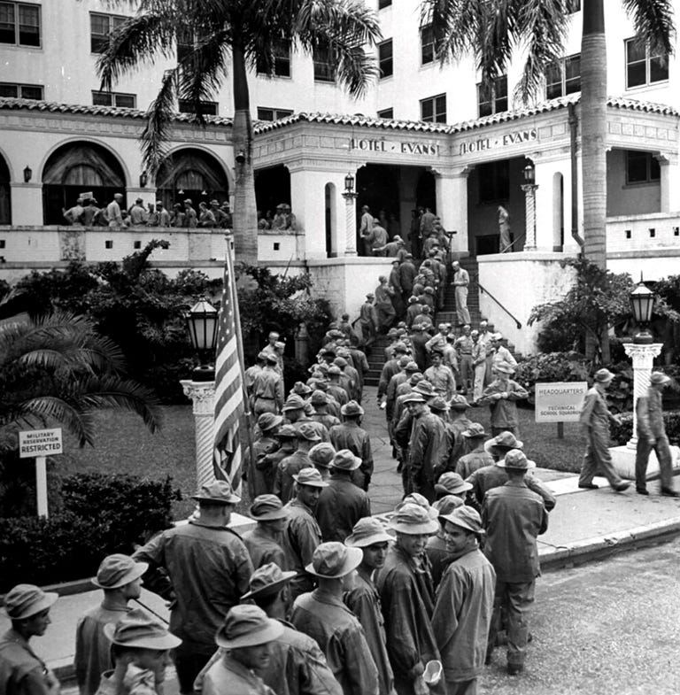Figure 6: Soldiers Standing in Line for Mess Hall at Hotel Evans in 1942