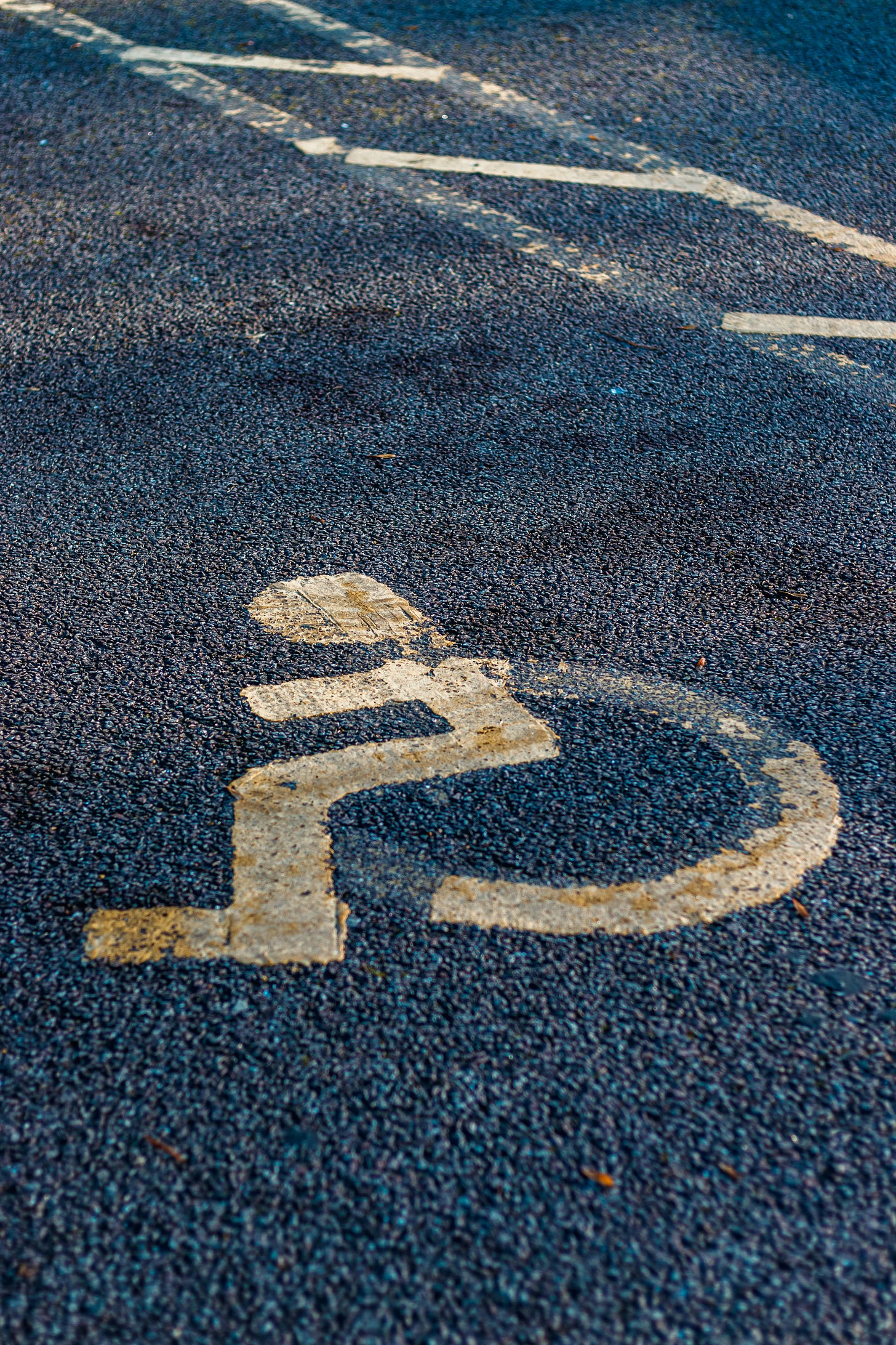 picture of a crip parking pace with the wheelchair man symbol