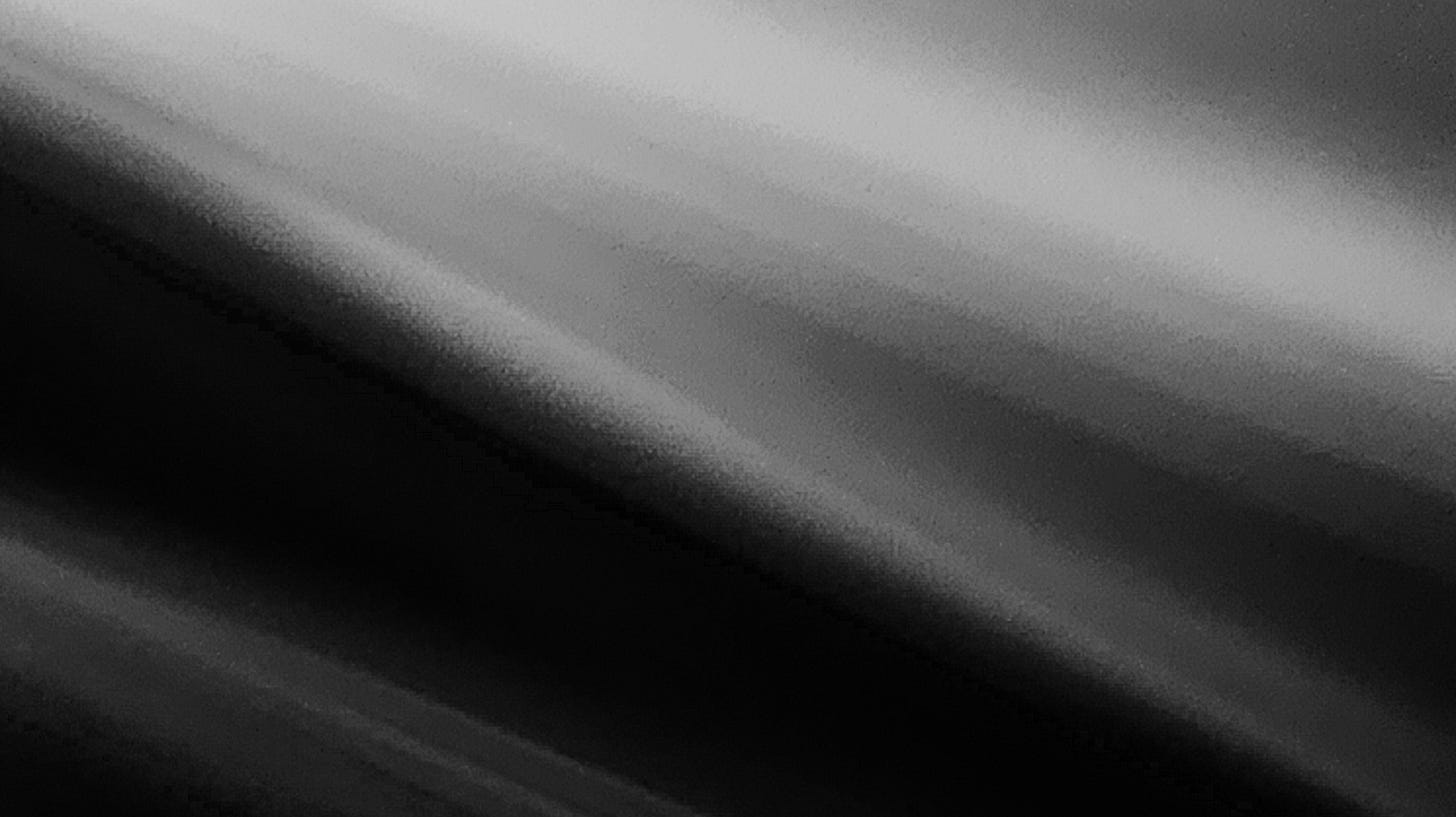 Grayscale photograph of a cast light pattern.