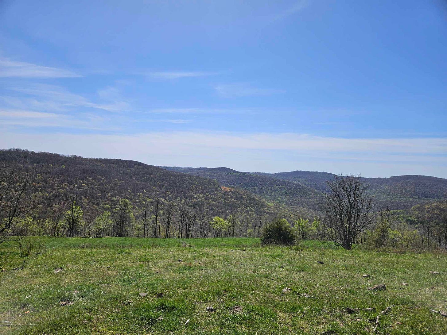 expansive view of wooded valleys below mountain top in Swain, Arkansas just before the eclipse of 2024