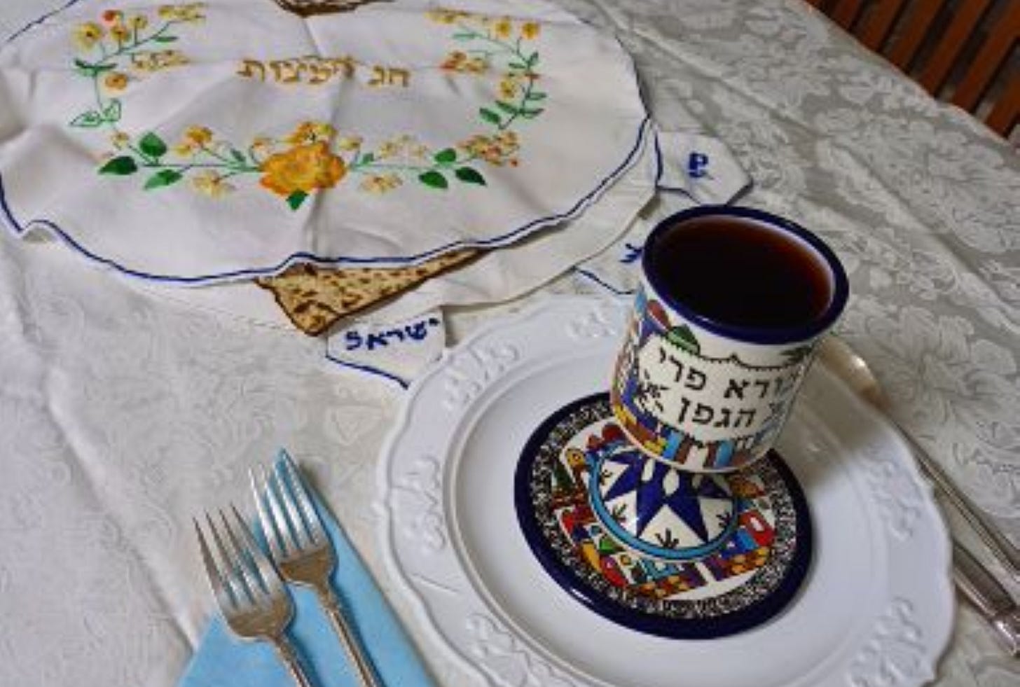Passover table with matzos and goblet of wine