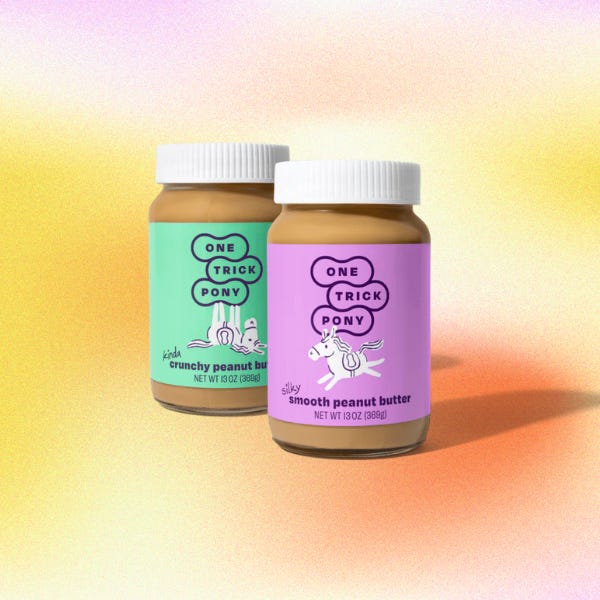 Two jars of peanut butter on a gradient background