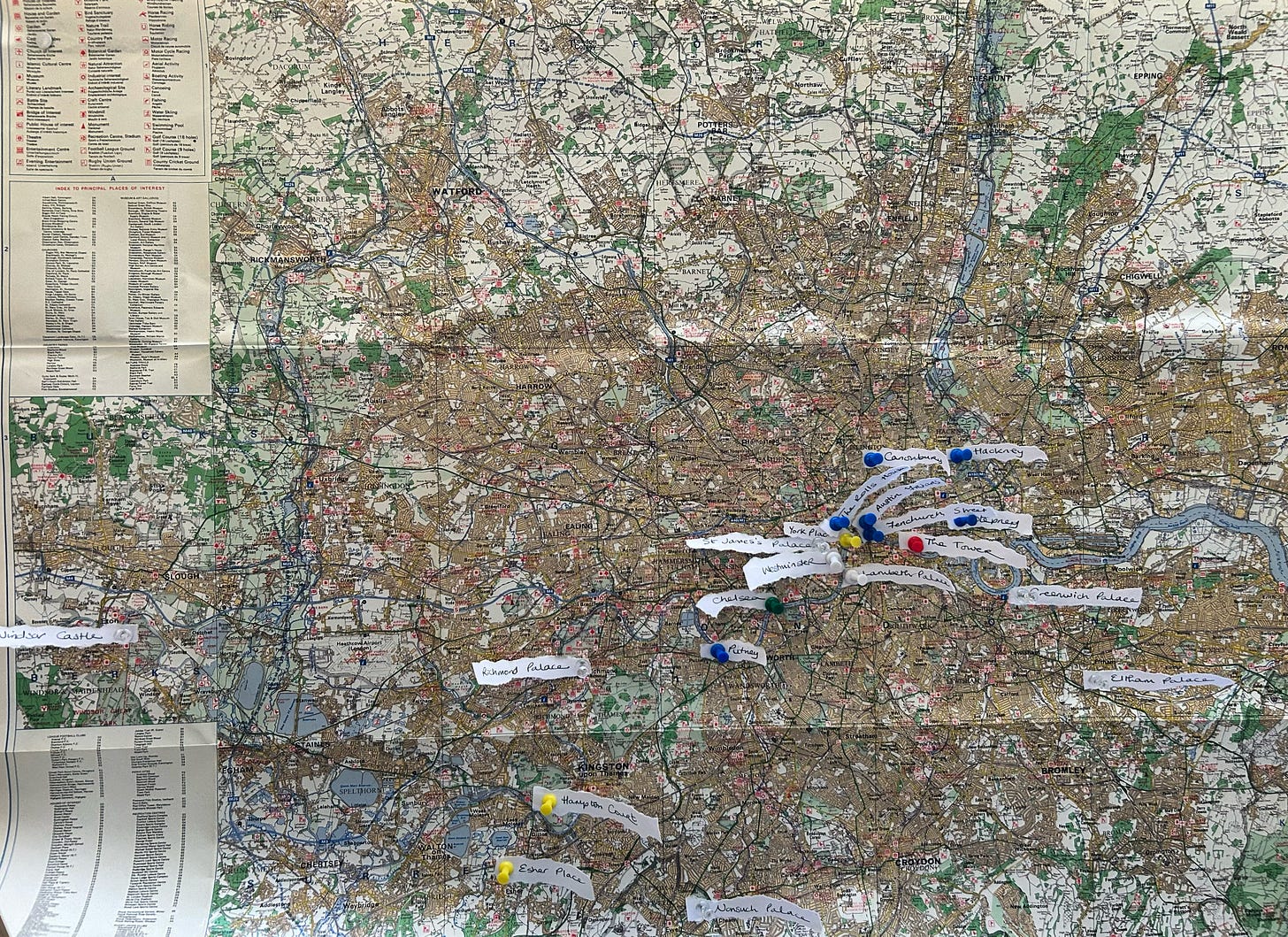 A map of Greater London, with pins and small strips of paper to mark locations