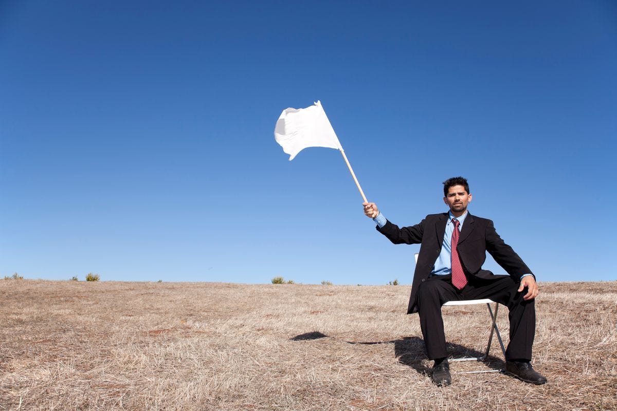 Um homem de terno acena uma bandeira branca de rendição.