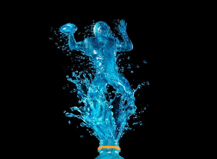 This may contain: a blue bottle with water splashing out of it's top and the bottom