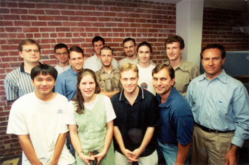 The early days at PayPal. Levchin (back left, white shirt) and the early team at PayPal limited the number of agonising hiring decisions by bringing in people they knew. The first 10 engineers at PayPal went to school with Levchin, including Luke Nosek (back right). The first five business hires came from Peter Thiel's (blue shirt in front of Levchin) network at Stanford.