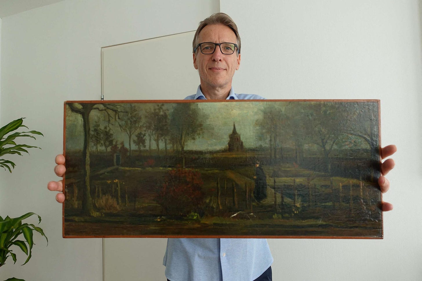 Dutch Detective Arthur Brand Holds stolen painting from Van Gogh "The Parsonage Garden at Huen in Spring"