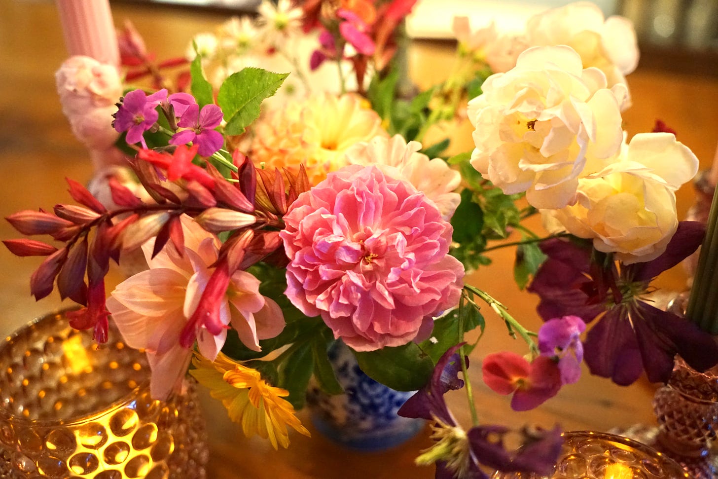 A jug of flowers by candlelight