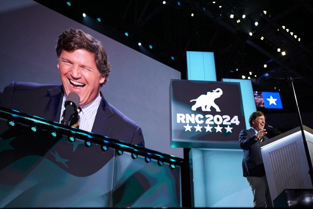 Tucker Carlson arrives to speak on stage on the fourth day of the 2024 Republican National Convention.