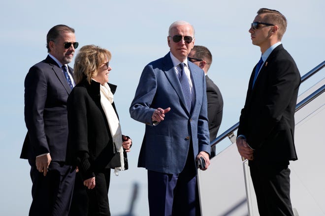 President Joe Biden gestures before he walked over to talk with reporters before boarding Air Force One, Tuesday, April 11, 2023, at Andrews Air Force Base, Md. Biden is traveling the United Kingdom and Ireland in part to help celebrate the 25th anniversary of the Good Friday Agreement. With Biden are his son Hunter Biden, left, and sister Valerie Biden(AP Photo/Patrick Semansky)