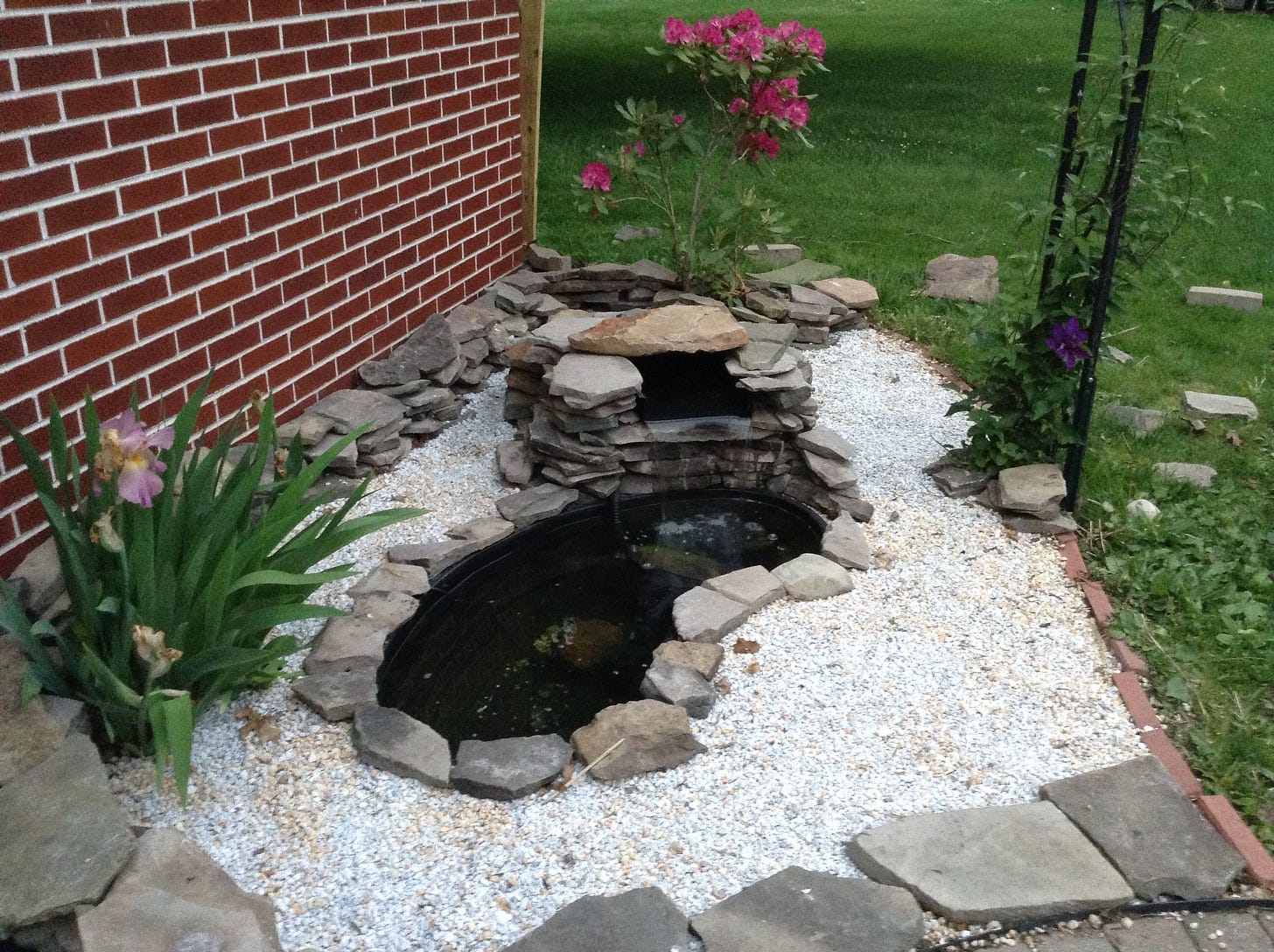 Small fish pond with pebbles and stones and waterfall. | Garden pond ...