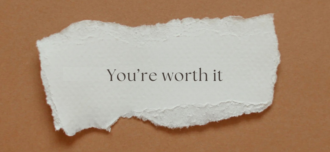 A ripped piece of paper says, “You’re worth it.” 
