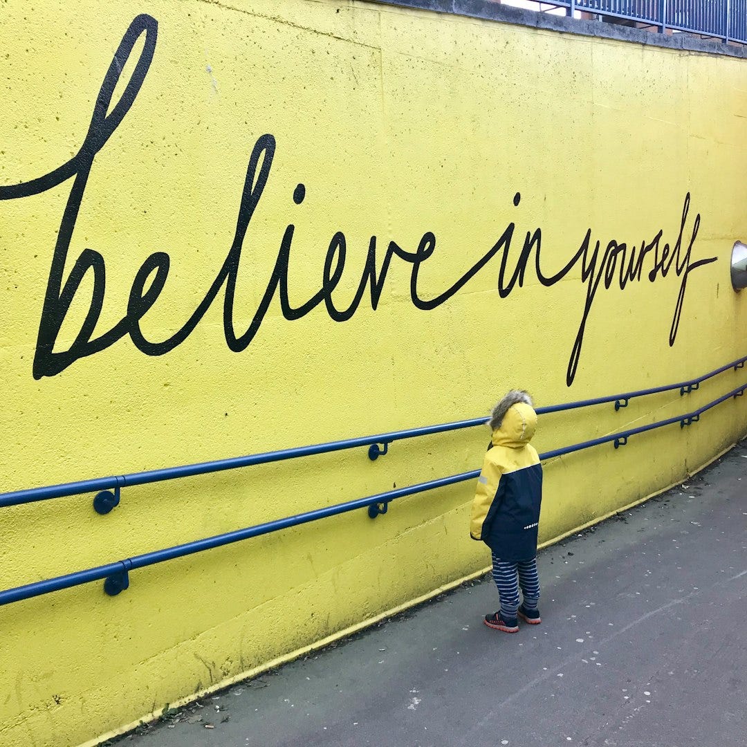 toddler looking at believe in yourself graffiti toddler looking at believe in yourself graffiti