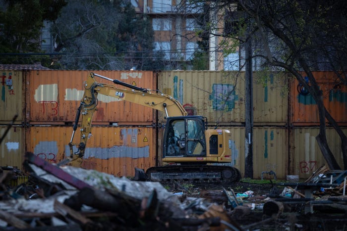 UC Berkeley and other authorities continue to clear People's Park and place giant shipping containers and stack them by twos to barricade the park on Thursday, Jan. 4, 2024 in Berkeley, CA.