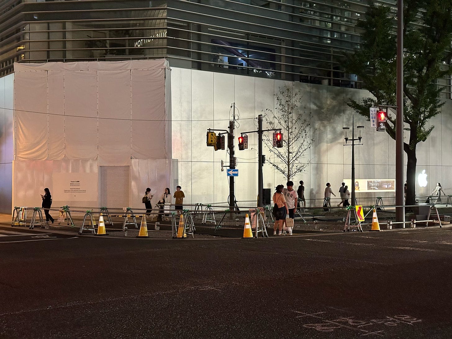 The exterior of Apple Shinsaibashi. The front of the store is under construction and covered with a white wall.