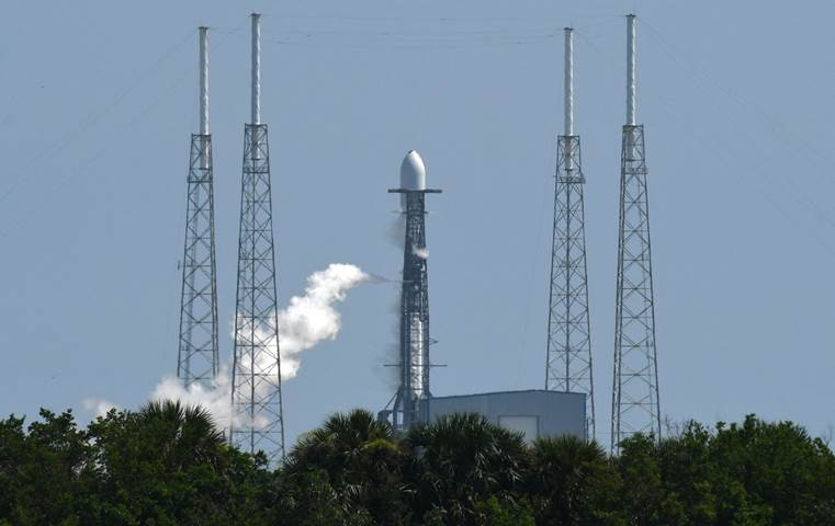 A rocket launch with several towers

Description automatically generated