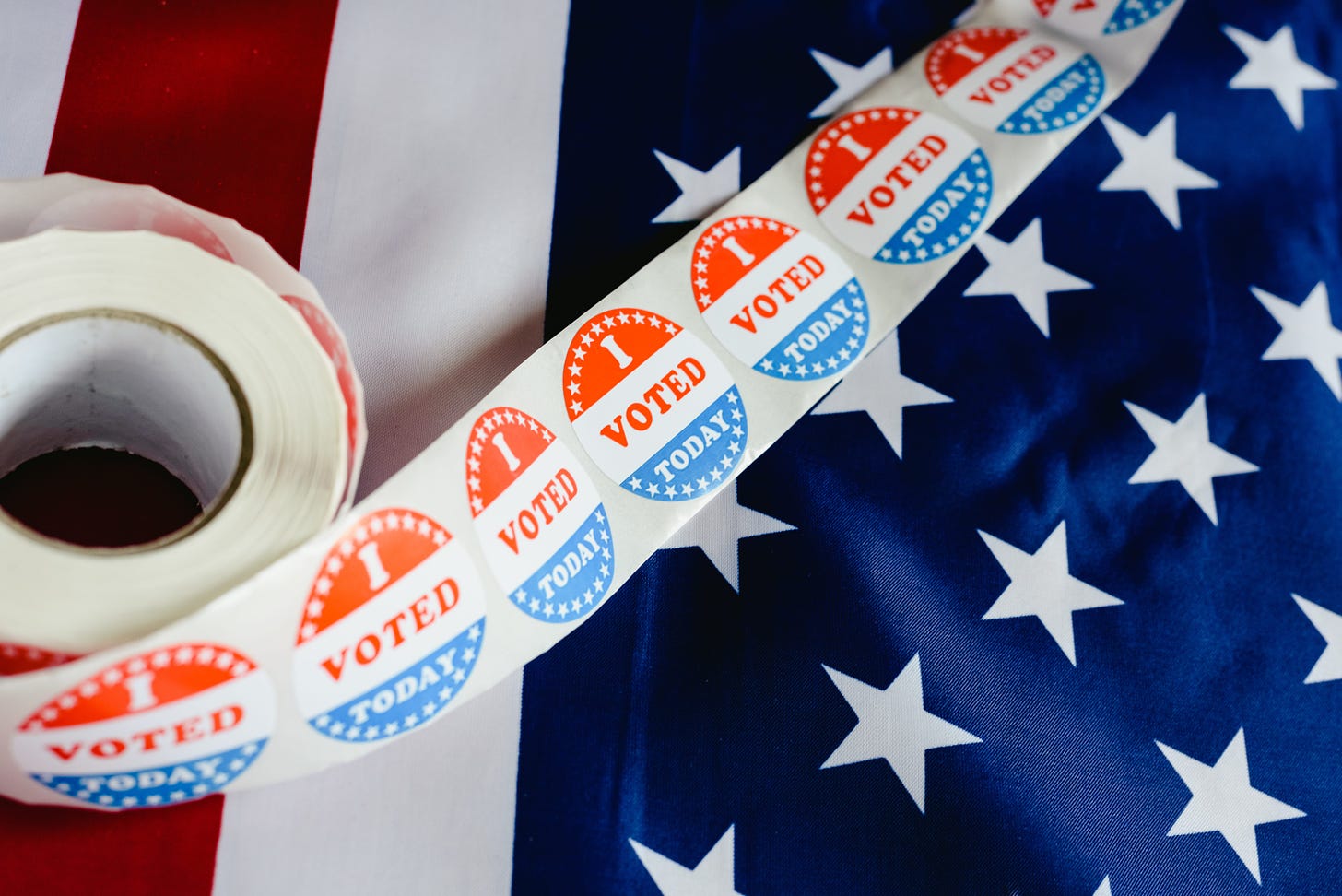 A roll of "I Voted Today" stickers on an American flag