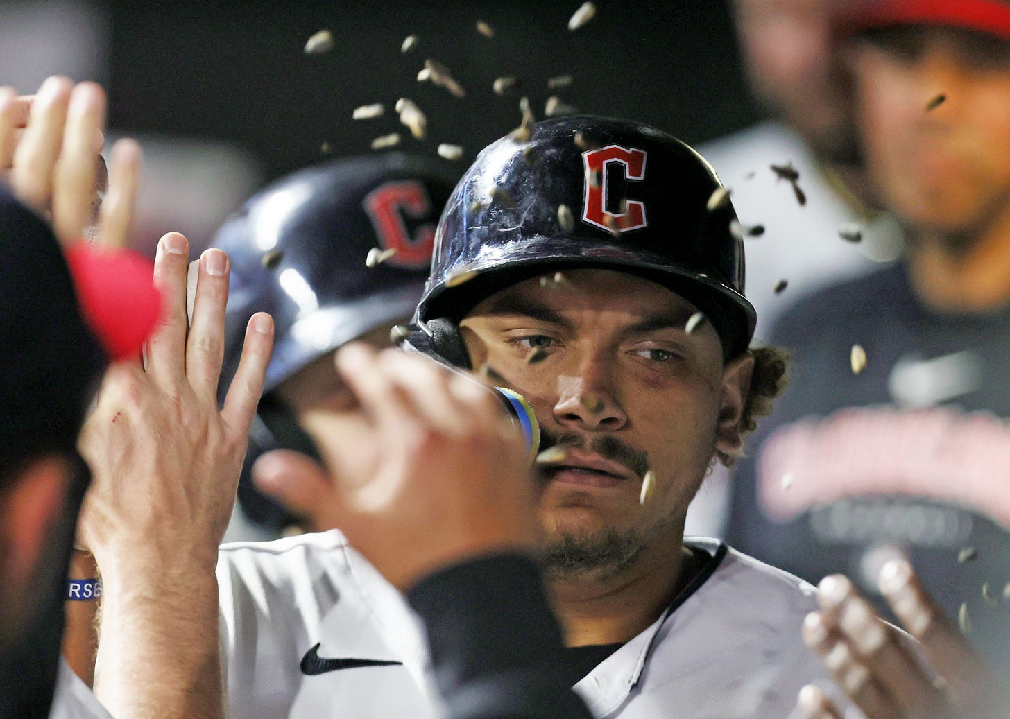 Cleveland Guardians first baseman Josh Naylor is showered with sunfire seeds by teammates in the dugout after hitting a home run in the eighth inning, May 12, 2023, at Progressive Field.