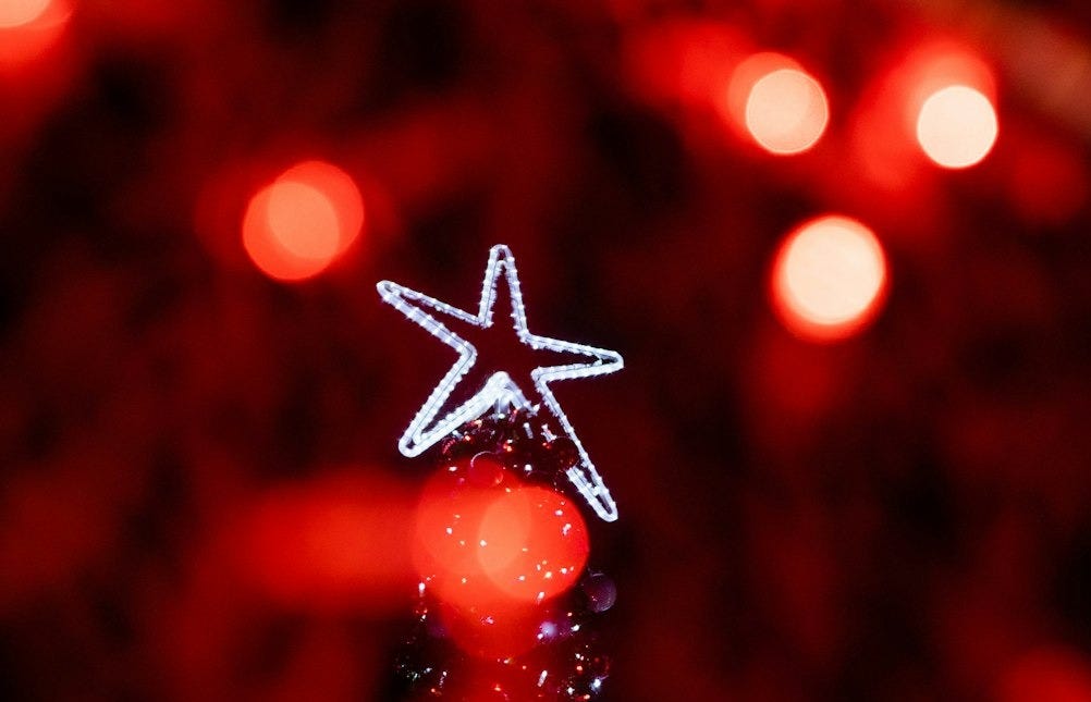 a lit up christmas tree with a star on top