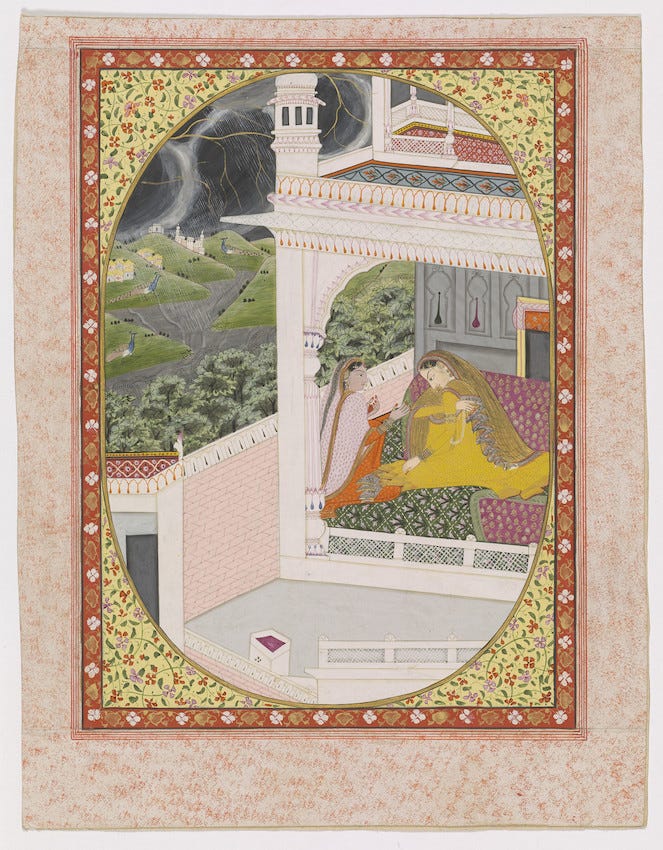 A detailed Indian miniature painting showing two women in an open courtyard under stormy skies. Around them in the landscape, peacocks are dancing, while rain falls in torrents and lightning strikes. One women, in yellow robes and veil, is looking disconsolately downwards, while her friend, in orange clothes and pink dupatta, looks at her with one hand outstretched, in a gesture of comfort.