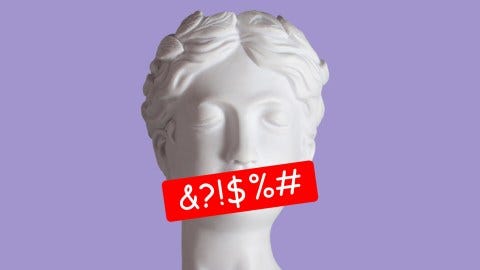 A bust of a woman with a red sticker on it.