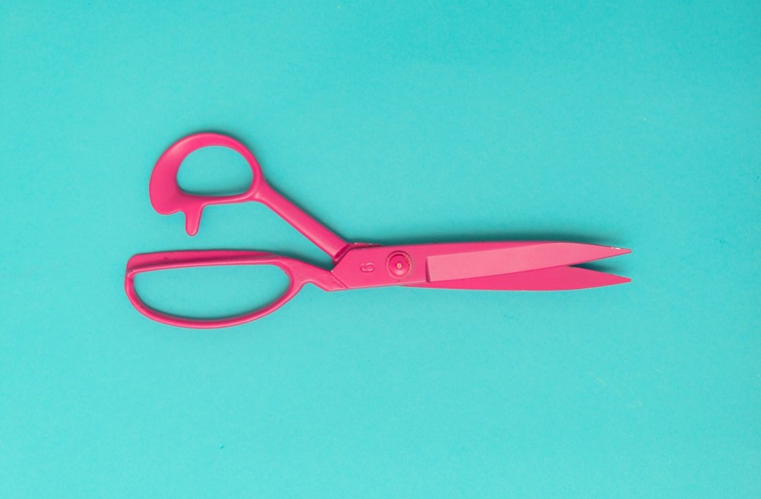 red handled scissors on blue surface red handled scissors on blue surface
