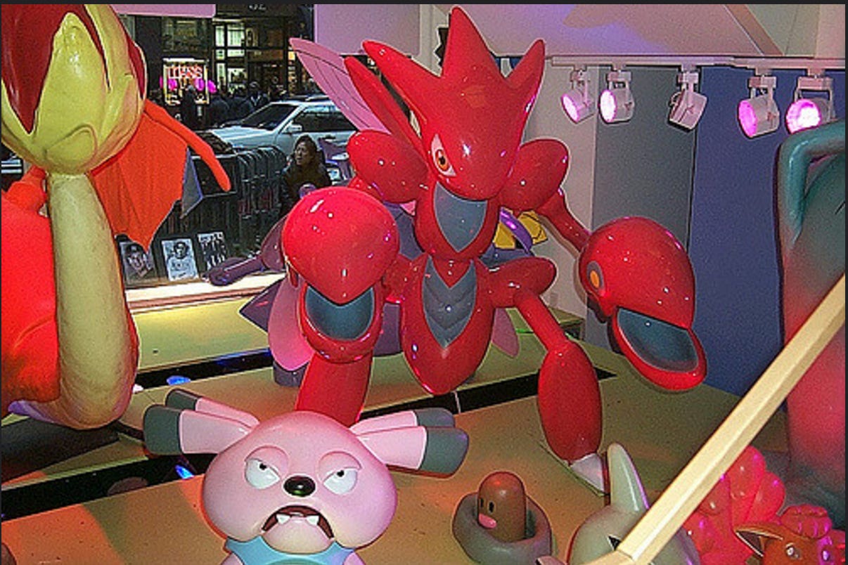 A photograph of some of the Pokémon animatronics and figures found in the original Pokémon Center New York store, including a Scizor, Snubbull, Digglet, Vulpix and Charizard.