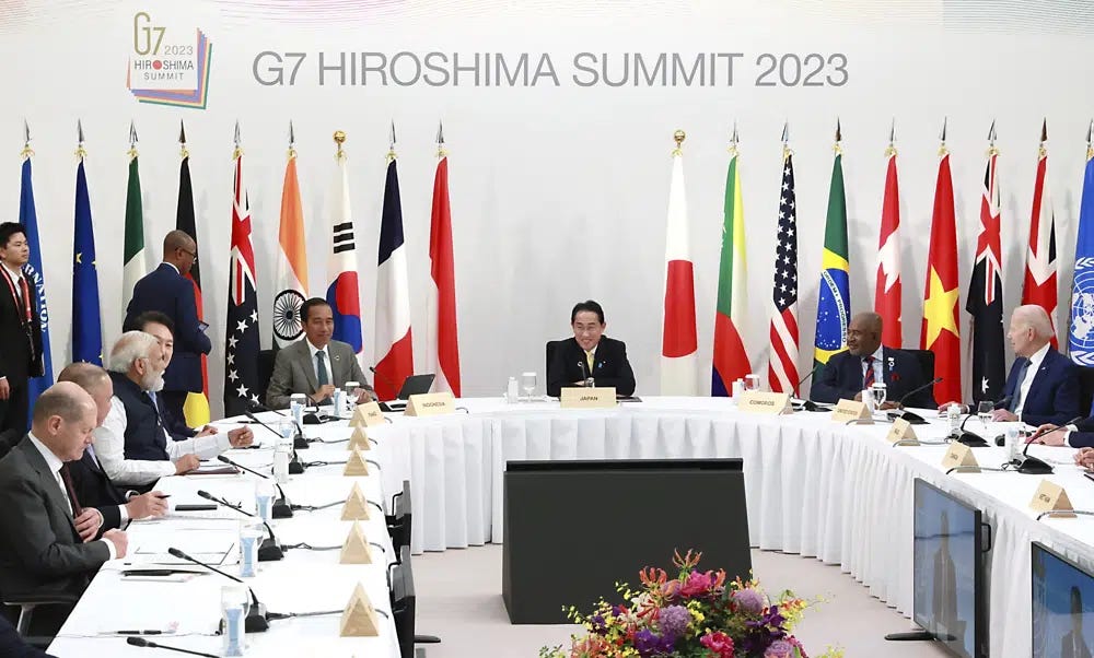 Leaders and delegates, including U.S. President Joe Biden, right, Japan's Prime Minister Fumio Kishida, center, Indonesian President Joko Widodo, center left, attend the G7 Outreach Session during the G7 Summit in Hiroshima, Japan, Saturday, May 20, 2023. (Japan Pool via AP)