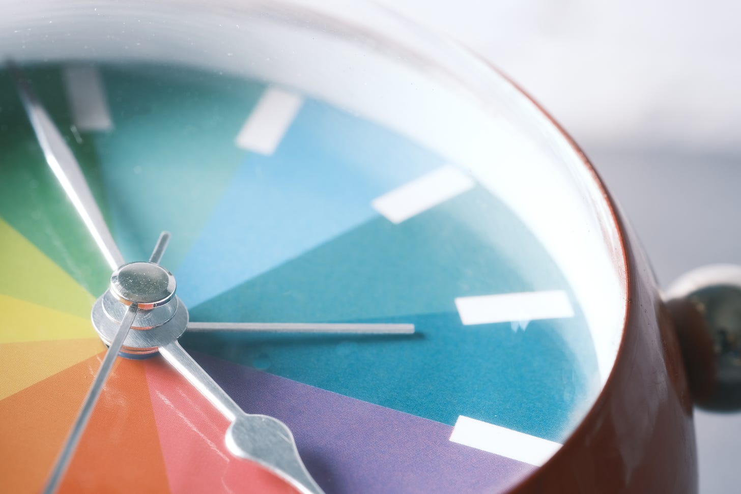 a clock with a rainbow face