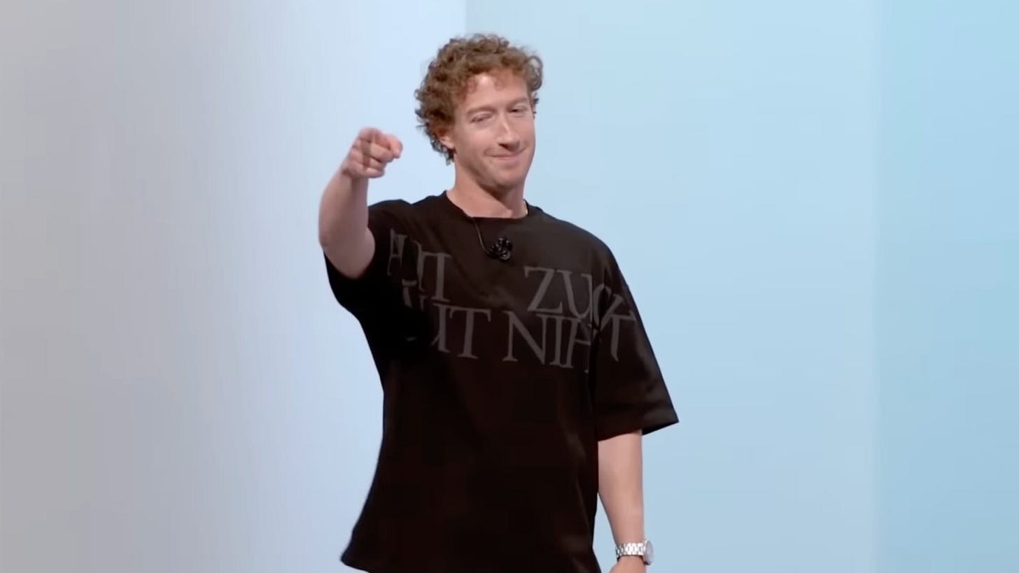 Mark Zuckerberg in a baggy shirt pointing to someone in the audience.