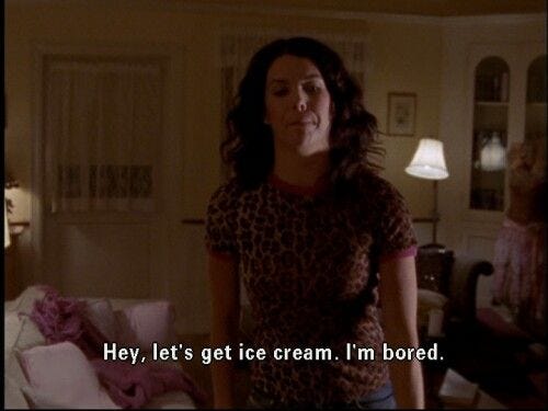 This may contain: a woman standing in a living room next to a couch with the words hey, let's get ice cream i'm bored