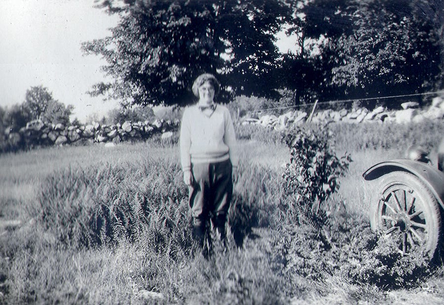 Woman with glasses standing in field