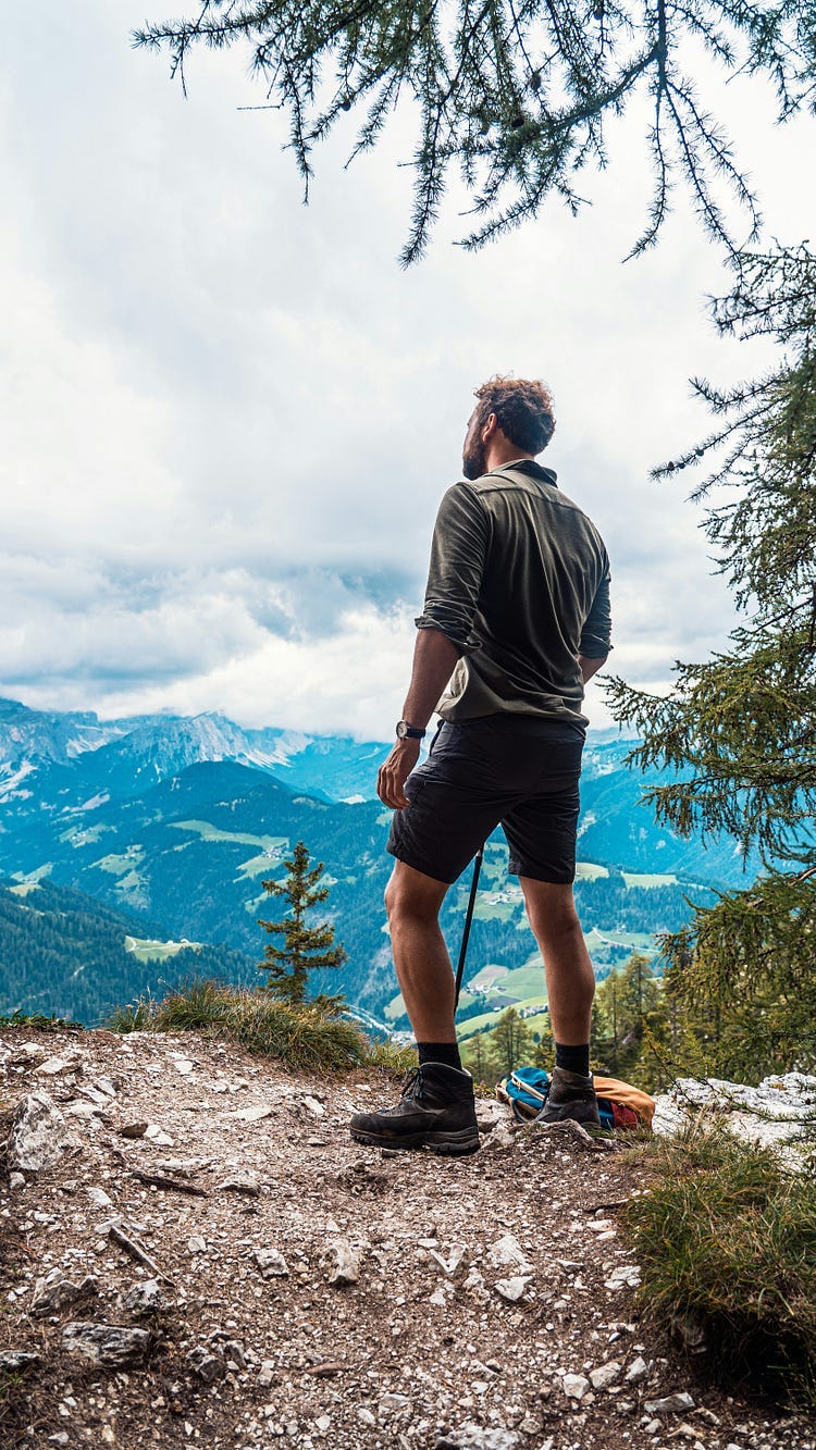 Hiker on a mountain looking at the view.