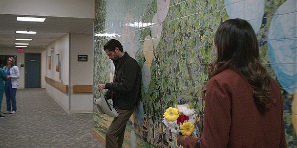 Geri finds Cordell Walker leaning on hall wall with hat in hand.