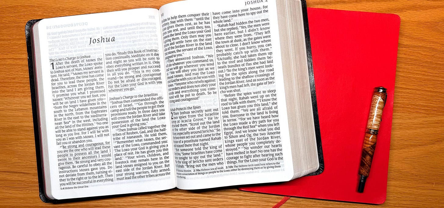 Open bible, journal, and fountain pen