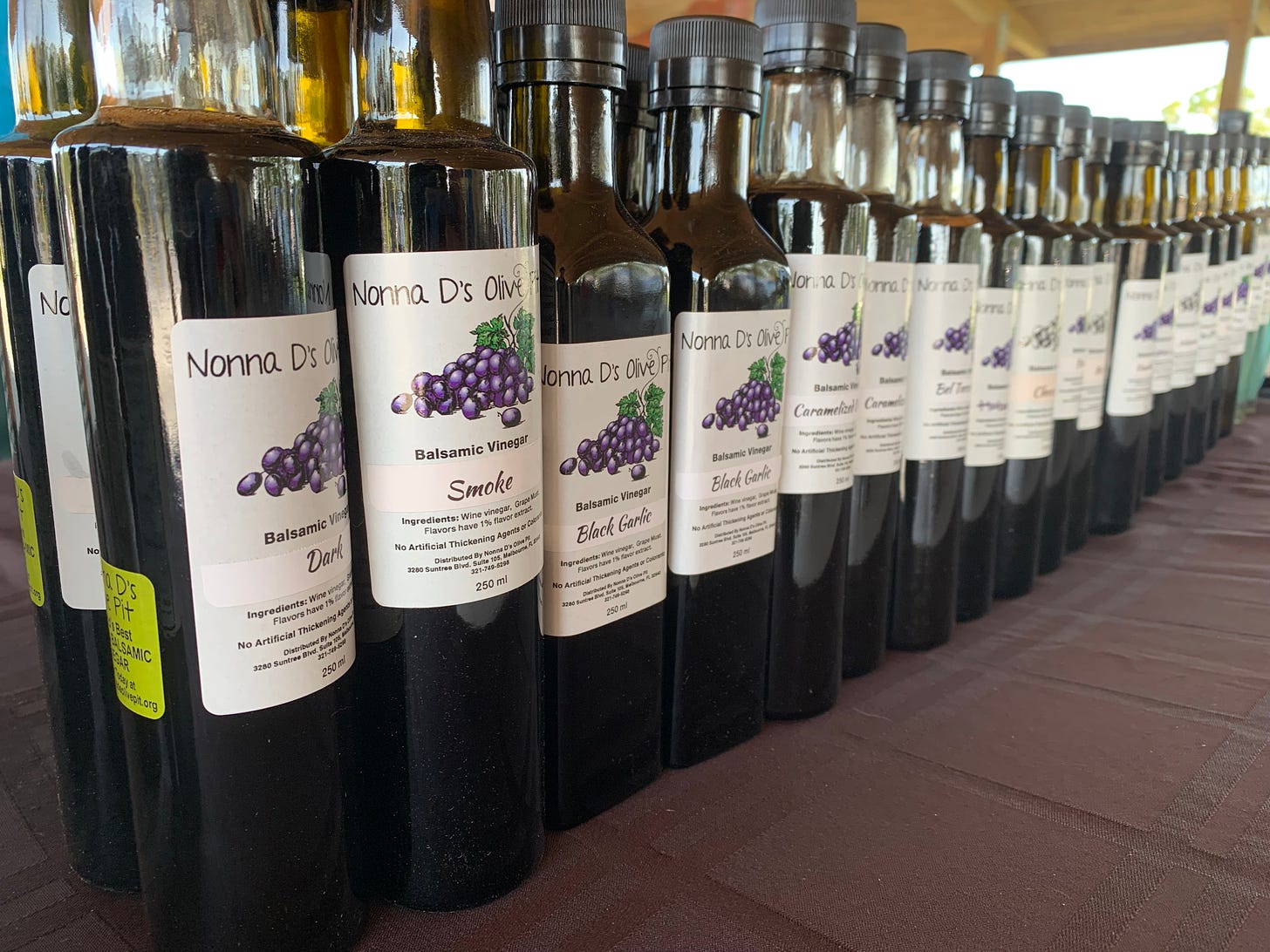 An angled shot of Nonna D's Olive Pit olive oil bottles