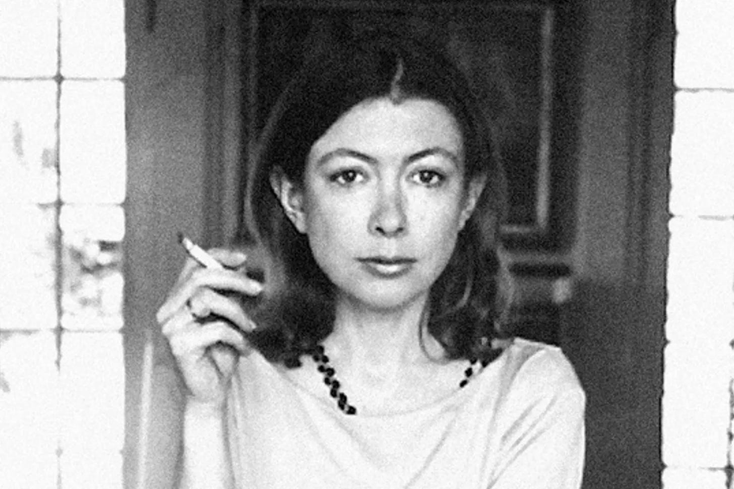 a black and white photo of writer Joan Didion holding a cigarette