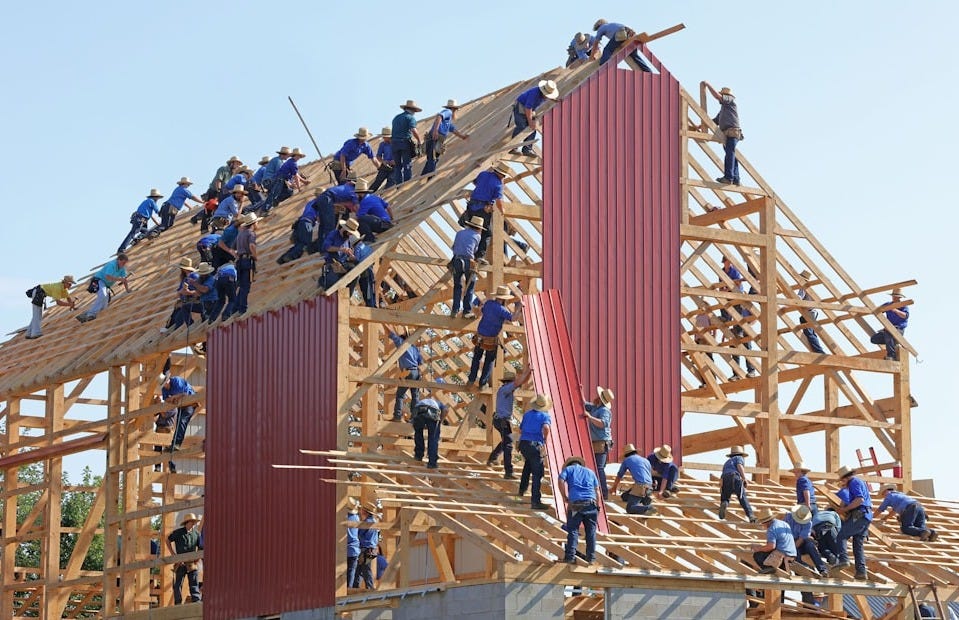 people building structure during daytime