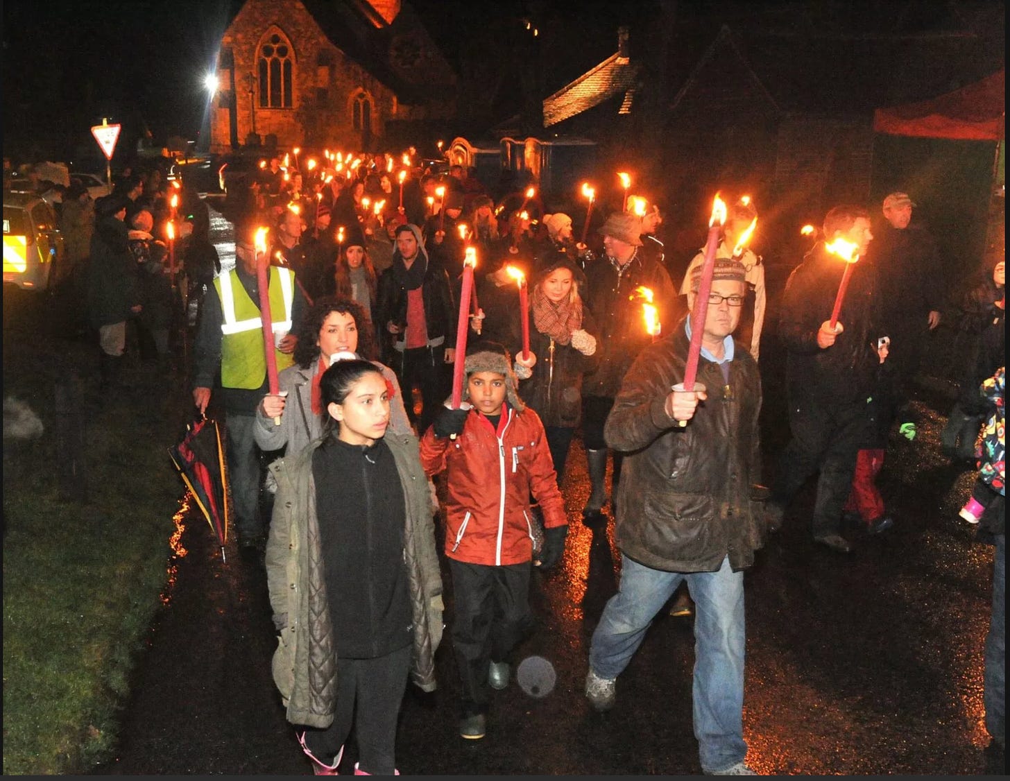 A group of people holding torches

Description automatically generated