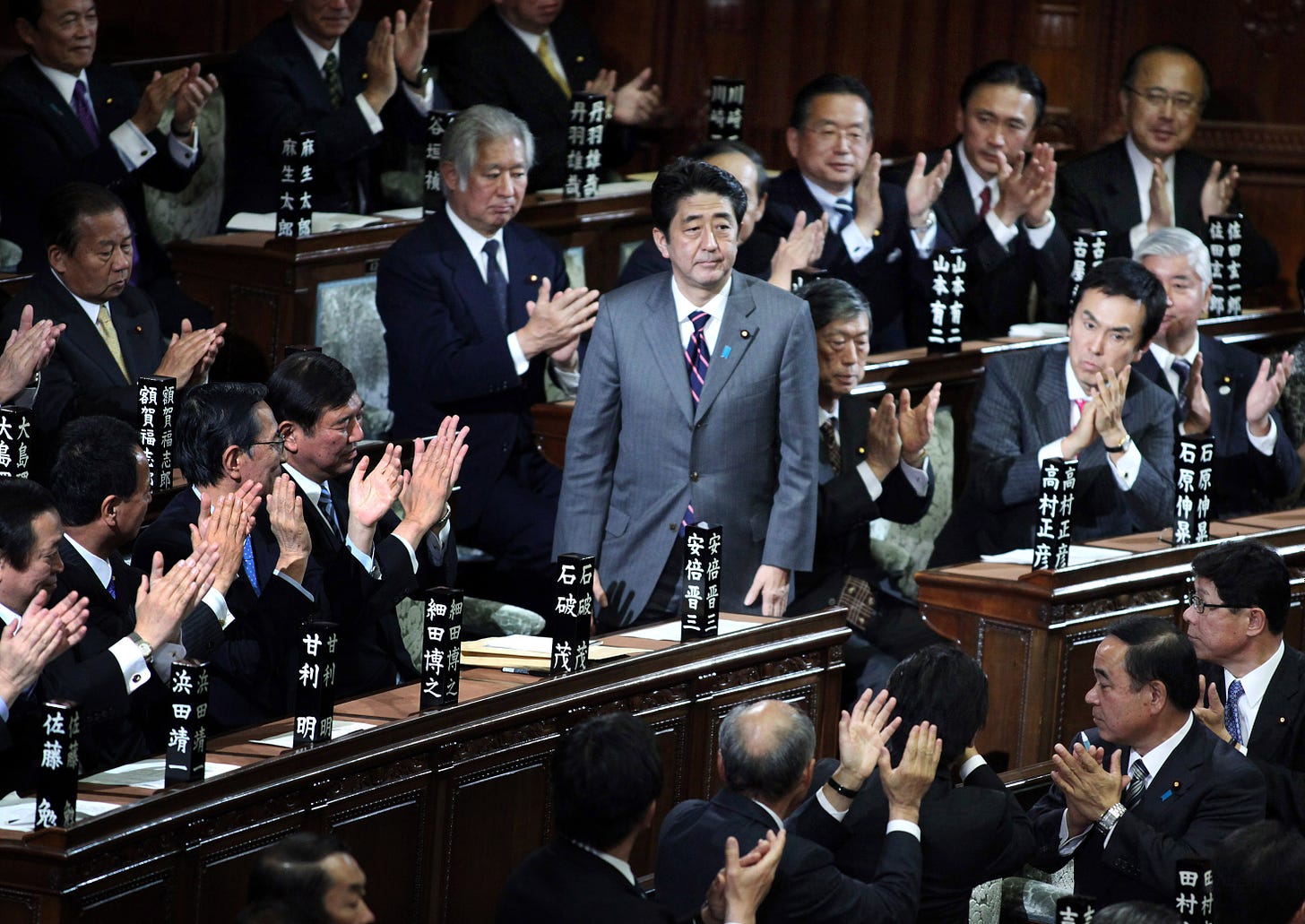 Shinzo Abe is applauded by a group of male colleagues after being elected prime minister in the Lower House in December 2012. Women are extremely underrepresented in Japan politics, where only 11.5 percent of all Diet members are female.  | BLOOMBERG