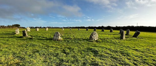 circle of ancient stones in grassy field