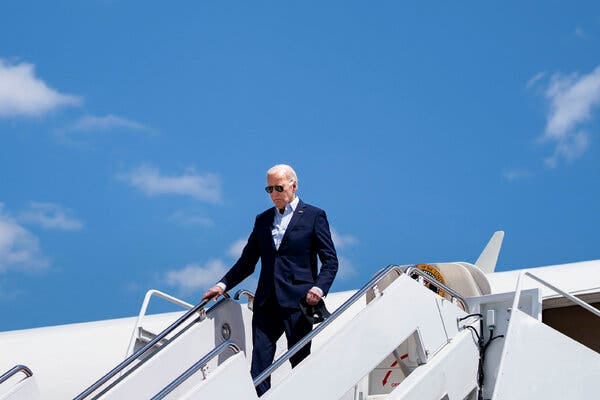 Joe Biden walks down stairs from Air Force One.