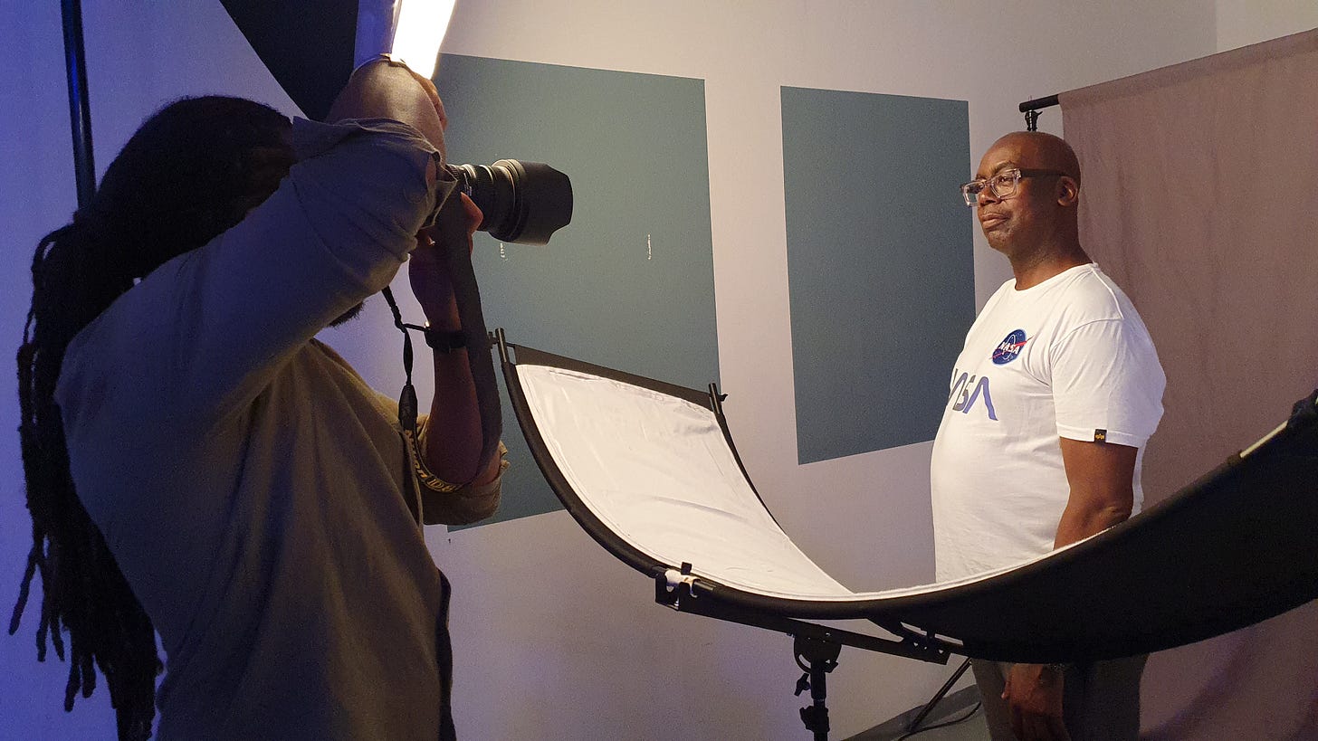 Patrick Vernon wears a NASA Tshirt and a photographer takes his photo